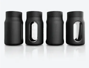 Four black cylindrical jars with windows.
