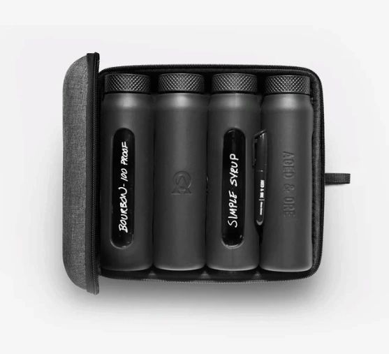 Black travel cocktail kit with labeled bottles.