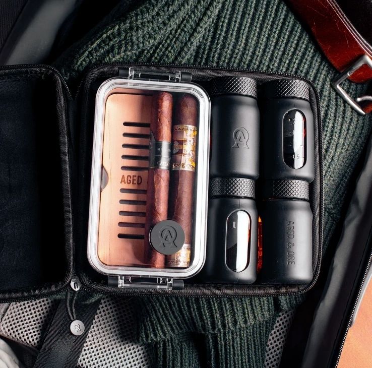 Cigar travel case with accessories and cigars.